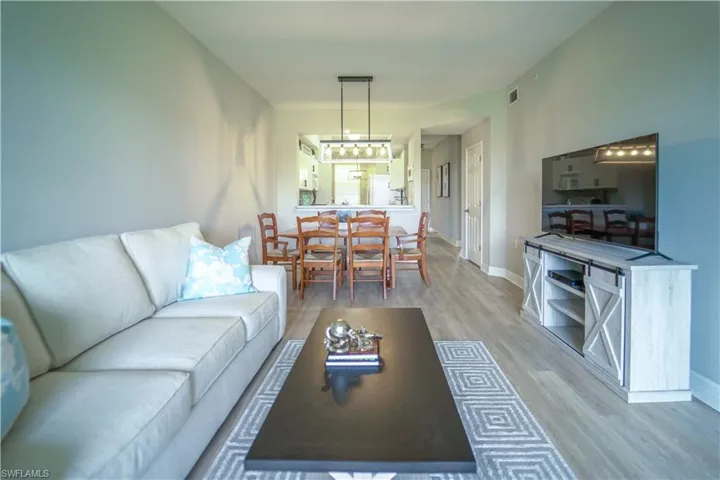 Living area featuring light wood-style floors and baseboards