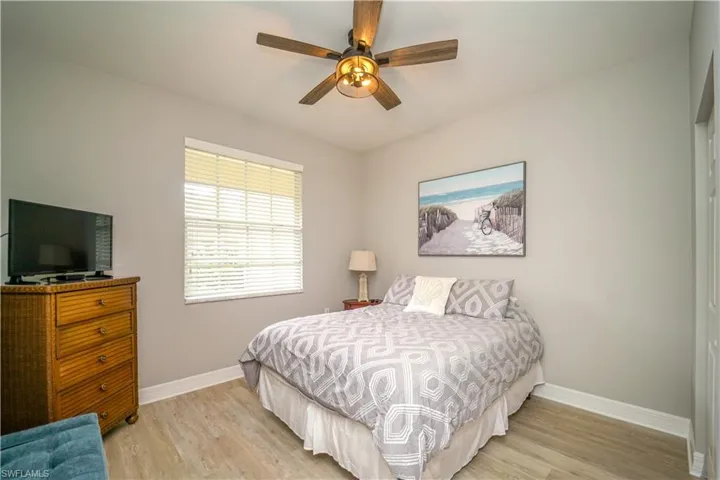Bedroom with light wood-style floors and a ceiling fan