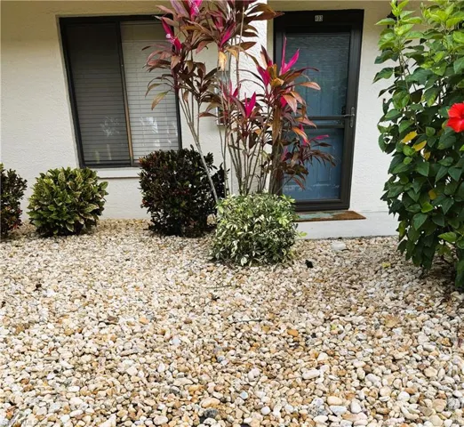 Property entrance featuring stucco siding