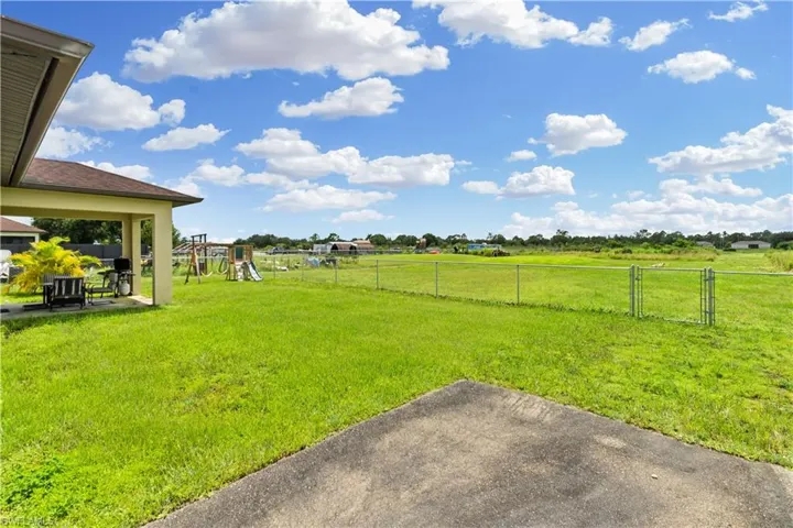 View of yard with a playground and a patio area
