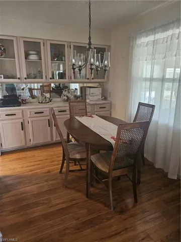 Dining space featuring a chandelier and large built in hutch.
