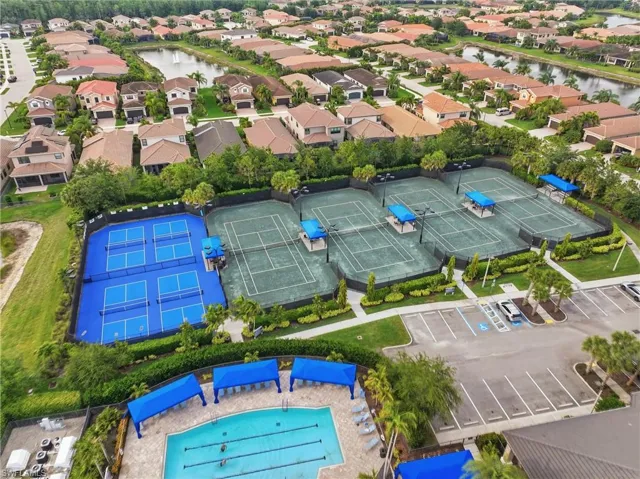 Community recreation area featuring a large swimming pool, six tennis courts, and four pickleball courts