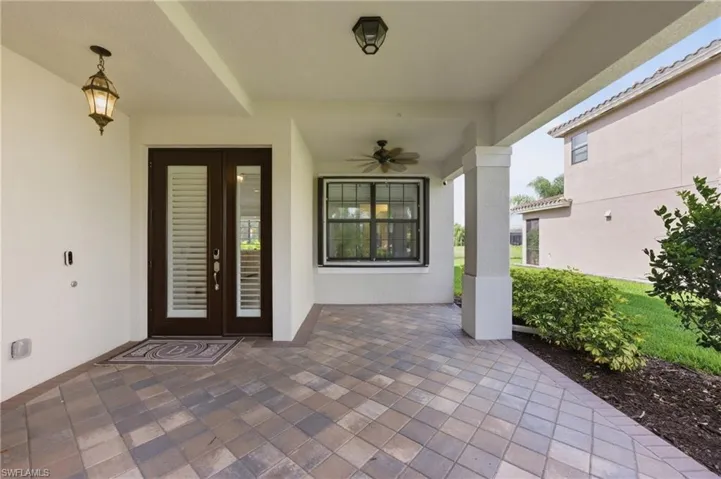 Covered entry patio featuring multi-toned paver flooring