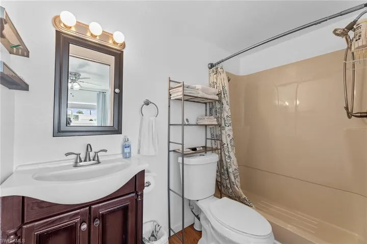 Full bathroom with toilet and vanity