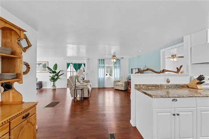 Kitchen featuring white cabinets and dark wood-type flooring