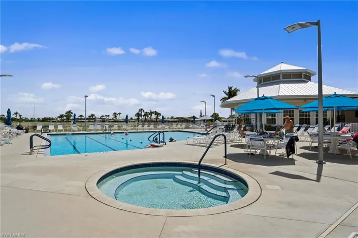 View of pool with a community hot tub and a patio area