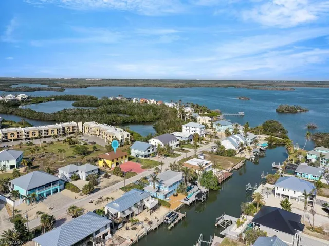Birds eye view of property with a water view