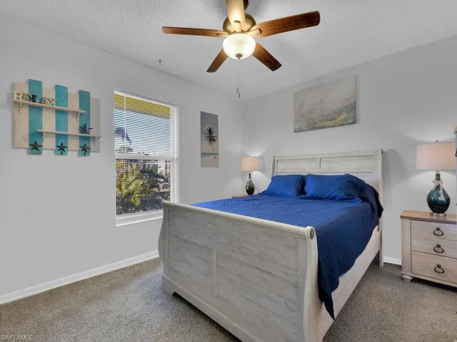 21602 Carpeted bedroom with ceiling fan and a textured ceiling