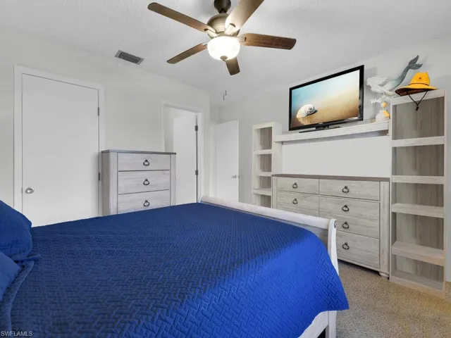 21602 Unfurnished bedroom with a textured ceiling, ceiling fan, and carpet flooring