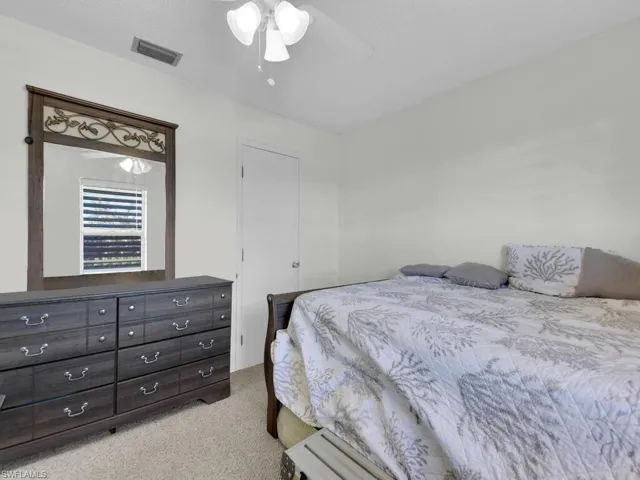 21602 Carpeted bedroom featuring ceiling fan