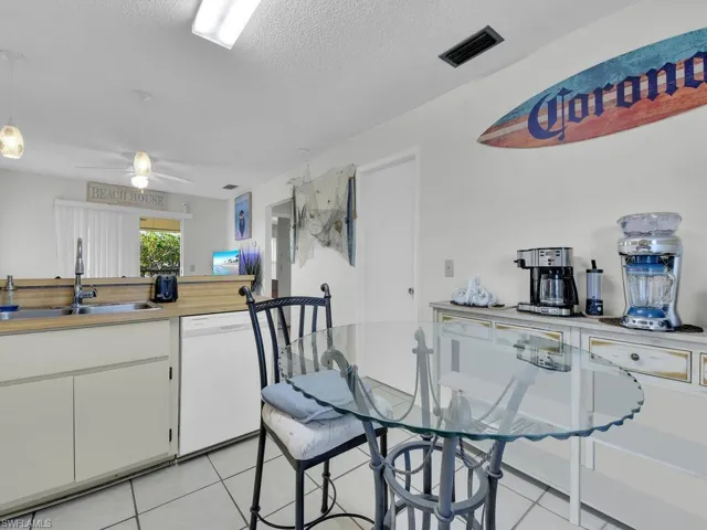 21602 Kitchen featuring a textured ceiling, white cabinets, ceiling fan, sink, and white dishwasher
