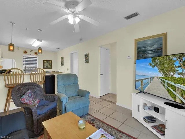 21600 Tiled living room with ceiling fan and a textured ceiling