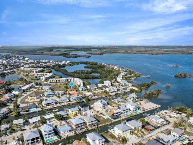 Birds eye view of property with a water view