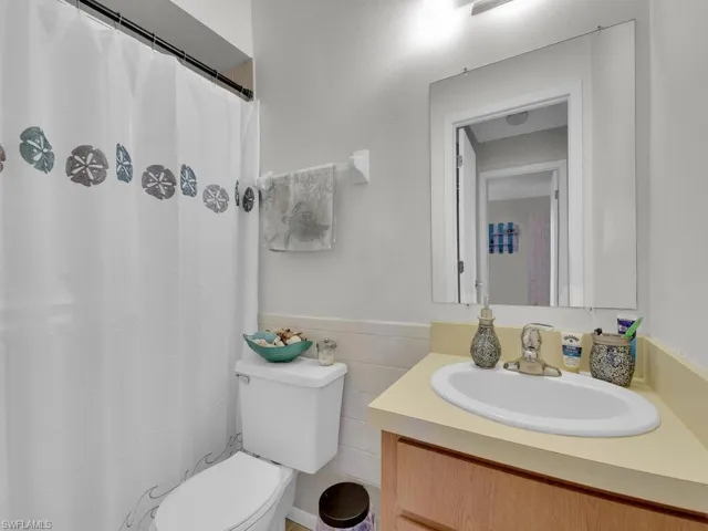 21602 Bathroom with toilet, tile walls, and vanity