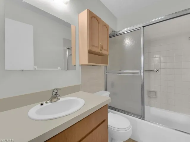 21602 Full bathroom with toilet, combined bath / shower with glass door, and vanity