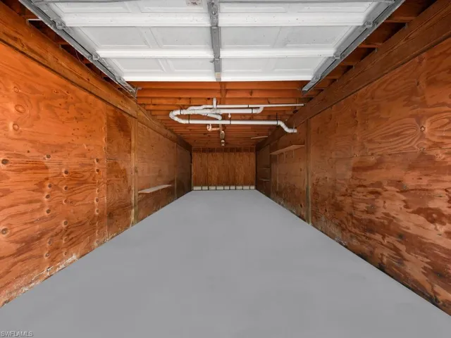 Garage featuring wooden walls