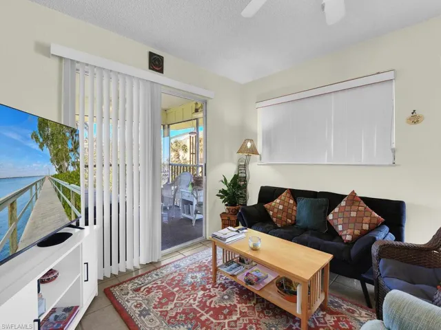 21600 Tiled living room featuring a textured ceiling