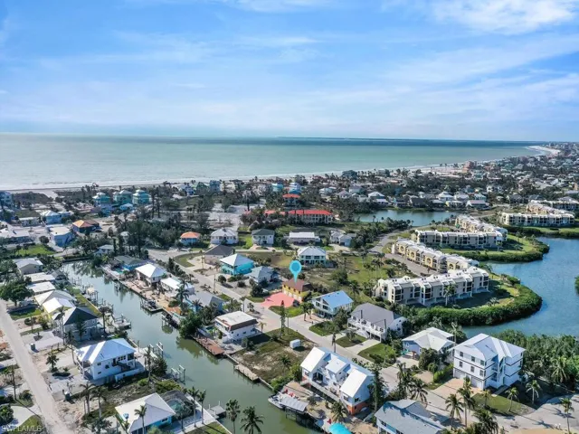 Birds eye view of property with a water view