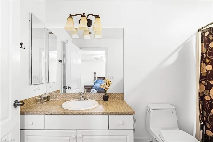 Ensuite bathroom featuring vanity and a shower with shower curtain