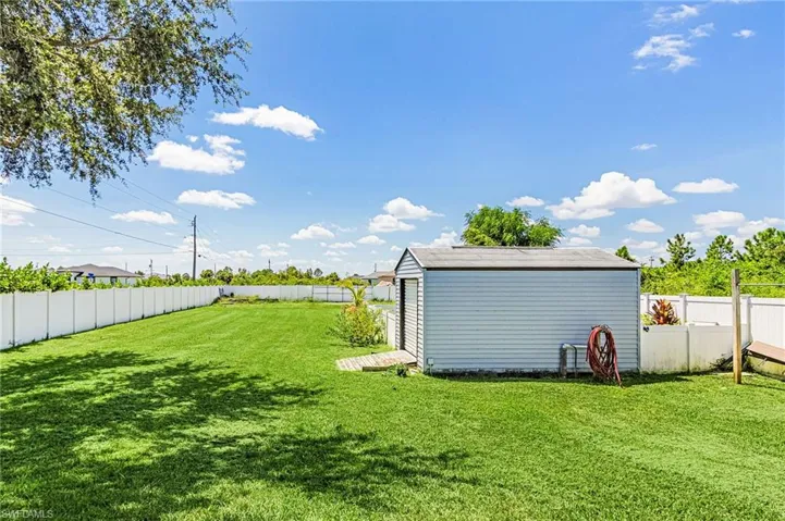 Fenced backyard with a storage unit