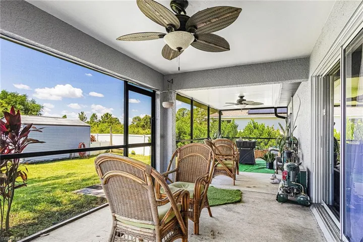 Sunroom / solarium with a ceiling fan