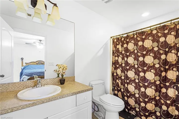 Ensuite bathroom featuring vanity and a shower with shower curtain