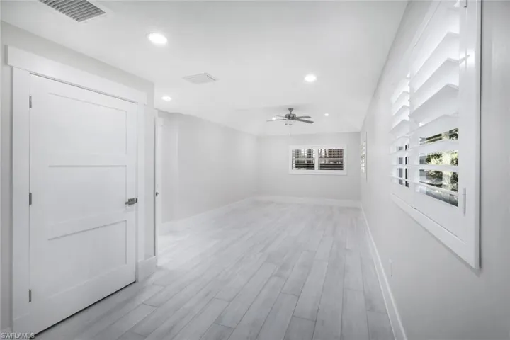 Empty room featuring baseboards, recessed lighting, a ceiling fan, visible vents, and light wood finished floors