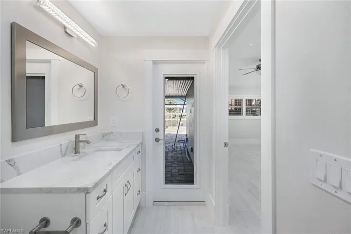 Bathroom with ceiling fan and vanity