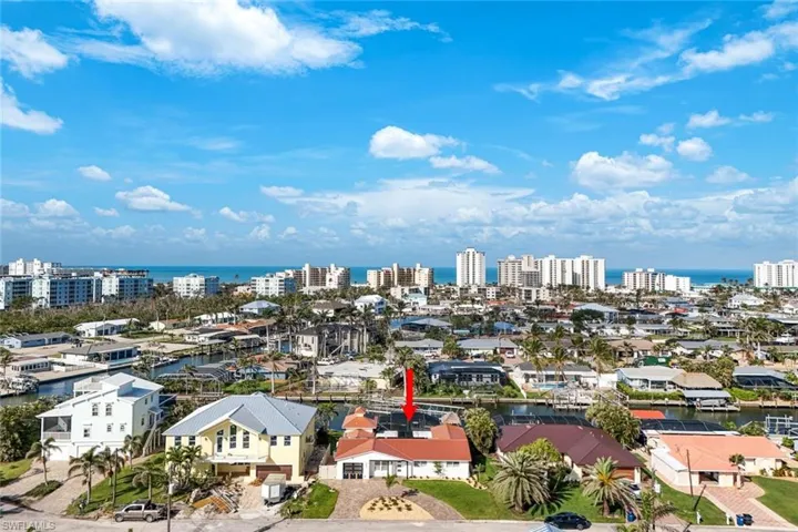 Aerial view featuring a water view and a view of city