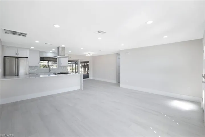 living room with porcelain plank tiled floors & recessed lights
