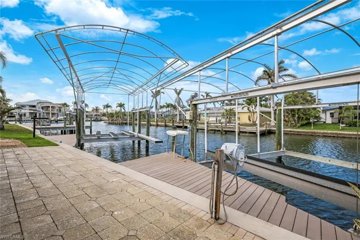 View of 2 boat lifts at dock with water