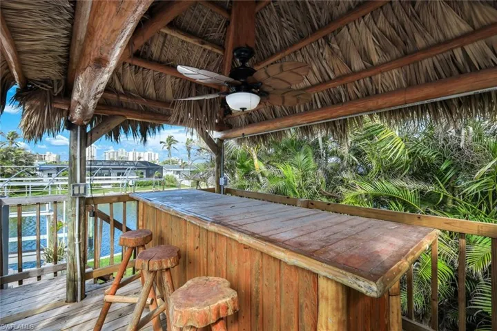 Deck with outdoor dry bar and a ceiling fan