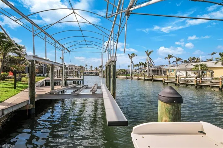 Dock area featuring boat lift and a water view