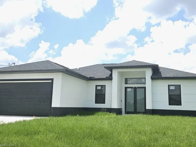View of front of home featuring a garage and a front yard