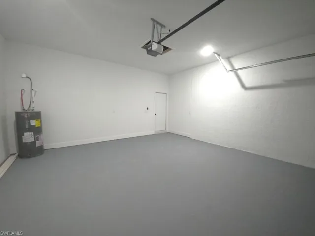 Garage with a garage door opener and electric water heater