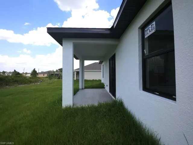 View of property exterior with a yard