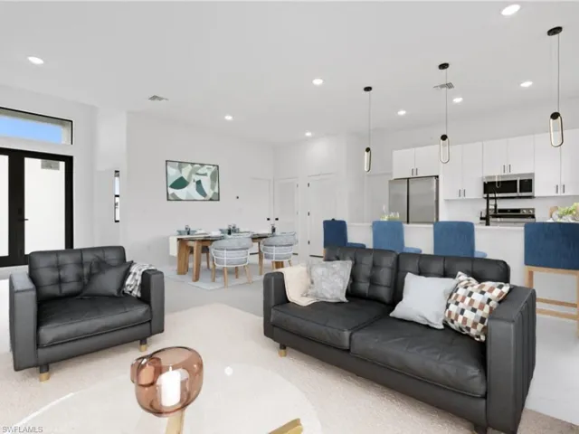 Living room featuring french doors and light colored carpet