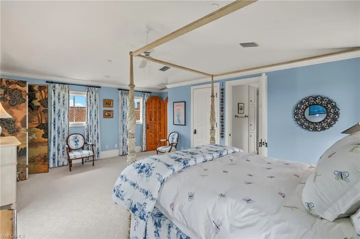 Bedroom featuring ornamental molding and carpet