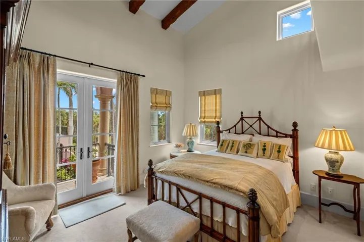 Bedroom with high vaulted ceiling, light colored carpet, access to outside, beamed ceiling, and french doors
