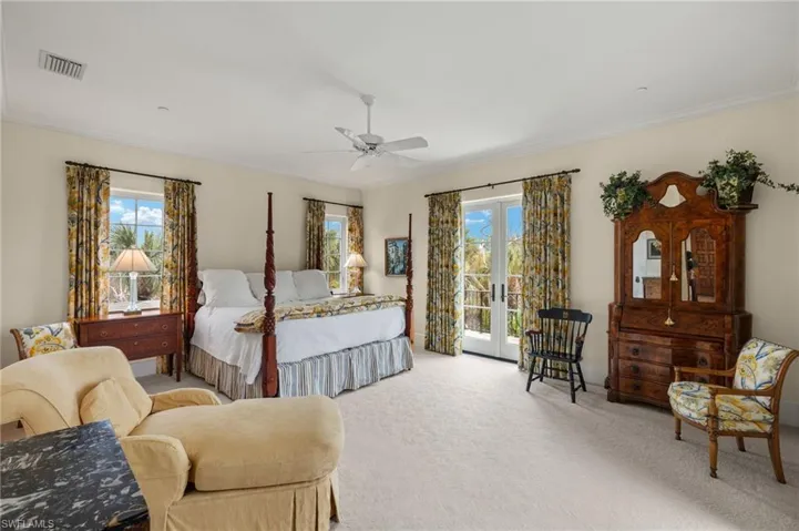 Bedroom with french doors, carpet, multiple windows, crown molding, and ceiling fan