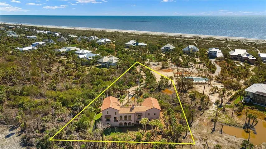 Aerial perspective of suburban area with expansive coastline and property parcel outlined