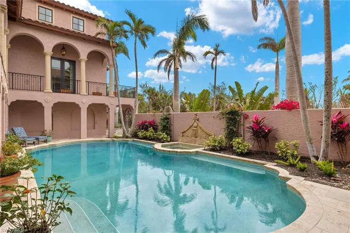 View of pool featuring a fenced backyard, a patio area, and a pool with connected hot tub