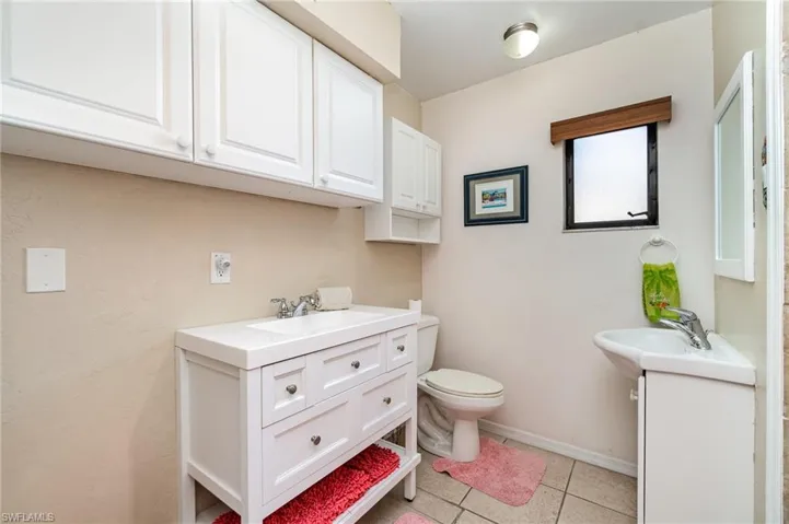 3rd Bedroom featuring tile patterned floors, a ceiling fan and window facing front of the home
