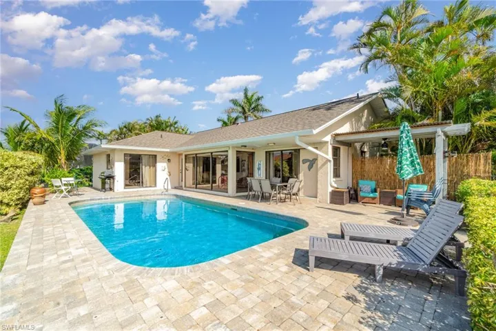 View of swimming pool with a patio and area for grilling and louging