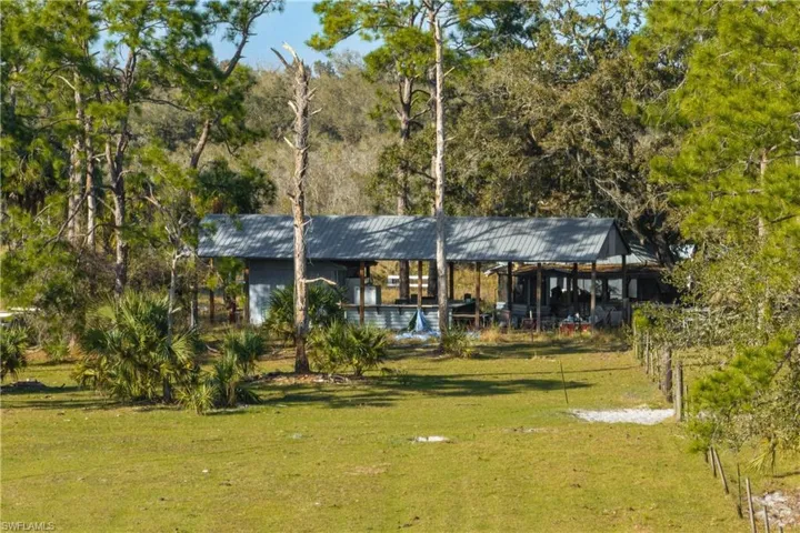 Back of house featuring a lawn