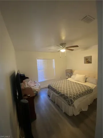 Bedroom with ceiling fan and baseboards