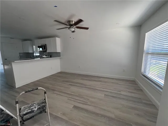 Bedroom with dark wood finished floors and ceiling fan