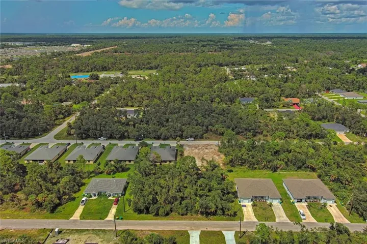 View of property location with a heavily wooded area and nearby suburban area