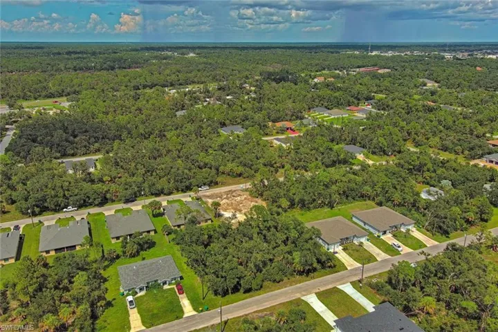 Aerial overview of property's location featuring nearby suburban area