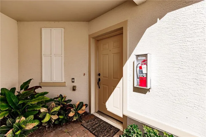 Property entrance with stucco siding